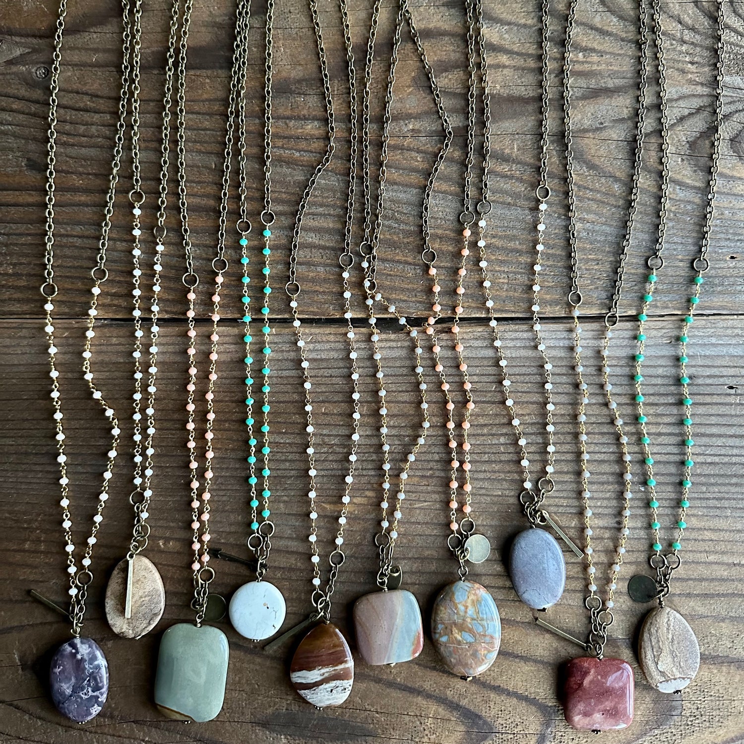 collection of beaded boho necklaces with different gemstones and unique charms